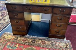 A modern oak pedestal desk fitted with 9 drawers.