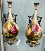 Royal Worcester, a pair of porcelain vases, each decorated with roses. Under glaze base marks