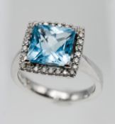 A modern 18ct white gold diamond and blue topaz ring, stamped 'YG 750', size M.