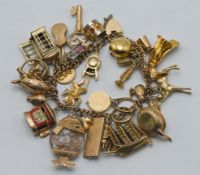 A 9ct gold charm bracelet with approx thirty one charms, approx 99.6g.