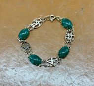 A Chinese jade set bracelet decorated with symbols not hallmarked, approx 8.30g.