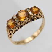 A 9ct yellow gold citrine and diamond cluster ring, approx weight of citrine 0.57ct and approx