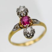 An antique ruby and diamond set three stone ring, size M.