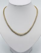 A 14ct yellow gold and diamond set necklace, length 46cm, set with approx 131 round brilliant cut