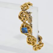 A gold twist antique bracelet set with a single synthetic sapphire (not marked), approx 23g.