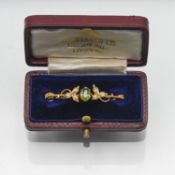A 9ct gold peridot and seed pearl brooch, with box.