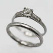A platinum diamond ring with diamonds to the shoulders, size I/J together with a platinum band ring,