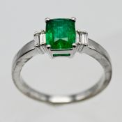 An 18k white gold emerald and diamond ring, size O/P.