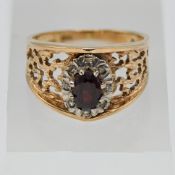 A 9ct yellow gold garnet and diamond oval cluster ring, approx weight of garnet 0.65ct and approx