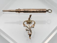 A gold propelling pencil set in 9ct, together with an art nouveau style gold pendant set with seed