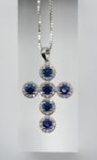 An 18ct diamond and sapphire set cross and chain.
