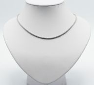 An 18ct white gold diamond line necklace, round brilliant cut diamonds with claw