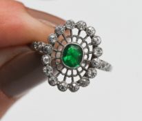A good early 20th century emerald and diamond filigree ring set in platinum, size O.
