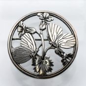 Georg Jensen - a round openwork brooch depicting two butterflies resting upon bellflowers, marked