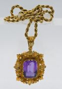 A large antique amethyst pendant set on gold chain marked 15ct, (pendant not marked).