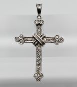 An 18ct white gold and diamond set cross, height 43mm, width 27mm.