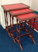 A Victorian style nest of three tables with red leather effect surface, max height 58.5cm. (3)