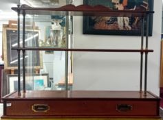 Campaign furniture. A 19th century mahogany and brass campaign bookshelf with fitted drawer,