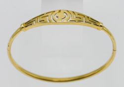A yellow metal, probably gold, Greek key pattern bangle, overall weight 8.7g.