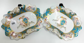 A pair of raised display bowls, decorated in Sevres style with gilt foliate imagery on blue ground