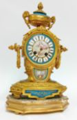 A 19th century French gilt brass mantle clock in Louis 15th style, with Sevres style painted