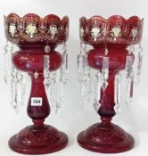 A pair of Victorian ruby glass lustre vases, height 36cm, with glass pendants and gilt painted
