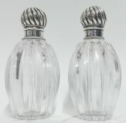 A pair of Victorian silver and glass perfume bottles, with engraved 'CA', hallmarked London 1889,
