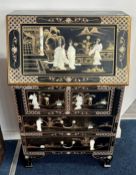 A modern small bureau/desk of Chinese design, in black lacquer with applied decoration