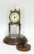 A brass anniversary clock with a glass dome, enamel dial, height 29cm.