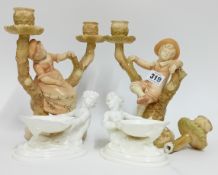 A late 19th century pair of Royal Worcester candlesticks, in the form of trees with figures of a boy