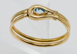 A 9ct bangle with topaz, overall weight 20g.
