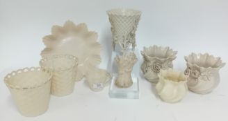 A collection of Belleek pottery, to include a pair of basket design vases and another on a stand,