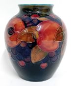A 20th century Moorcroft pottery vase, decorated in Pomegranate pattern, deep blue interior, circa