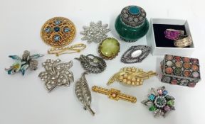 A collection of twelve brooches, together with two statement rings, and two decorative boxes. (16)