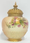 An early 20th century Royal Worcester blush ginger jar, with gilt details and floral design,