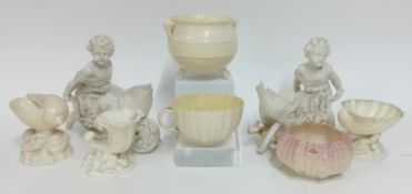 A collection of Belleek pottery, to include a pair of bowls modelled as leaf wheelbarrows pushed