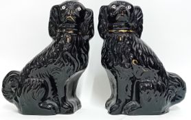 A pair of Staffordshire dogs, black with gilt details, height 34cm. (2)