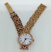 A 9ct gold Rotary watch, on a bracelet chain, roman enamel dial, weight 17.5g.