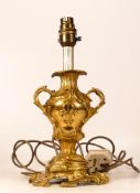 A Gilt Metal Rococo Lamp Base with Fleur De Lys Symbol. Height: 29cm