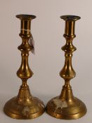 19th century circular base brass candlesticks, height 15cm, both push rods present
