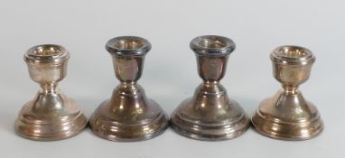 Two pairs of hallmarked silver candlesticks, little used and in good condition, 6.5cm & 7cm high -