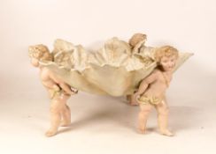 A Sitzendorf Fruit Bowl of natural leaf forms on four Putti Supports. Height: 15cm