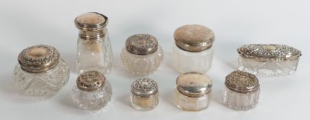 Nine x silver topped antique cut glass jars, some denting to most (9)