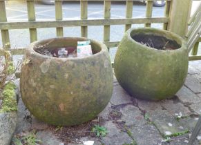 A pair of concrete garden planters