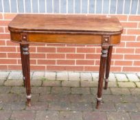 George III mahogany fold over card table with material interior. Measures 91cm x 45cm x 74cm high,