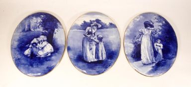 Three Royal Doulton Blue & White Oval Wall Plaques with Child Decoration, each length at largest