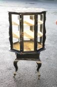 Large heavily carved revolving glazed collectors display cabinet, a fine and unusual example.