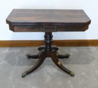 Early 19th century rosewood & brass inlaid swivel & fold over top, card table, measuring 91cm wide x