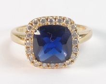 Dress ring, set with large blue paste stone surrounded by cz, yellow metal and tested to be 9ct or