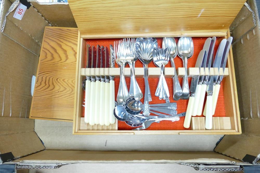 A collection of mixed cutlery in wooden display cases